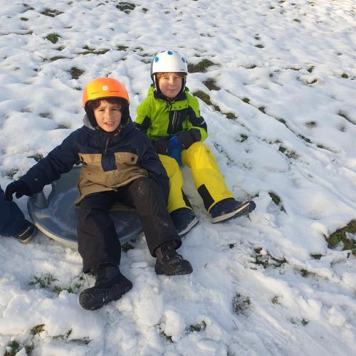 Kinder sitzen im Schnee