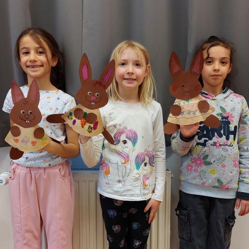 3 Mädchen halten gebastelten Osterhasen in der Hand