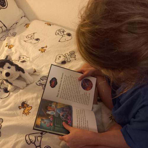 Mädchen liest im Bett