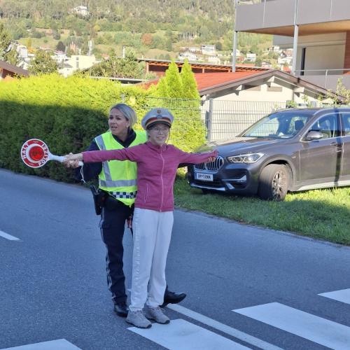 Mädchen darf mit der Polizistin den Verkehr regeln