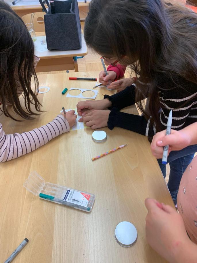 Kinder beschriften die Deckel